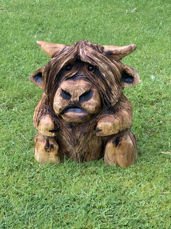 shaggy highland cow — chainsaw carving by Woodaknot chainsaw carving & sculpting