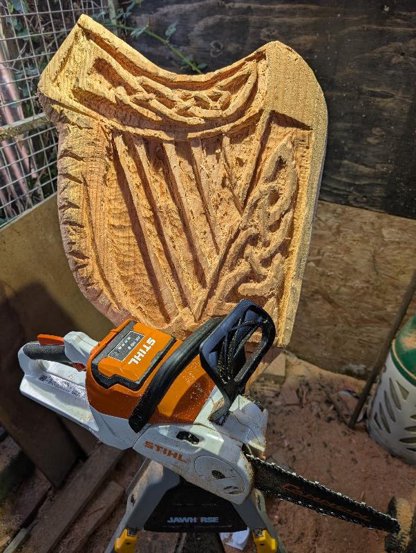 Celtic harp relief carving — chainsaw carving by The Grateful Tech